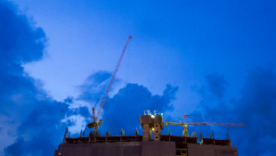 Study Finds Construction Cranes Vulnerable to Hacking Crane over dark blue sky