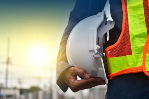 Construction worker holding hardhat