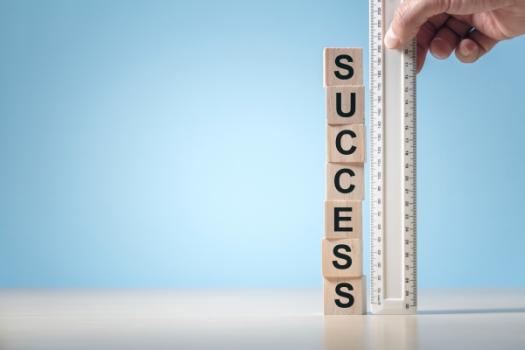 Success blocks next to ruler