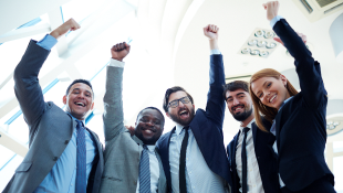 Business people raising arms in triumph