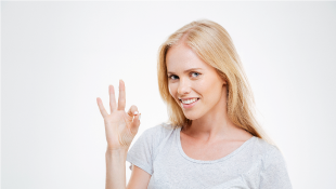 Woman smiling and doing okay sign with hand