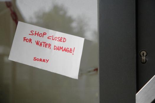 Shop closed due to water damage sign on window