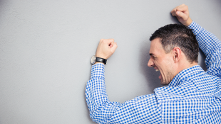 How to Remove a Mechanics Lien from Your Property Businessman beating hands against wall