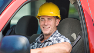 Construction worker in car smiling