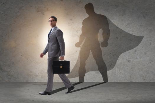 Businessman with superhero shadow