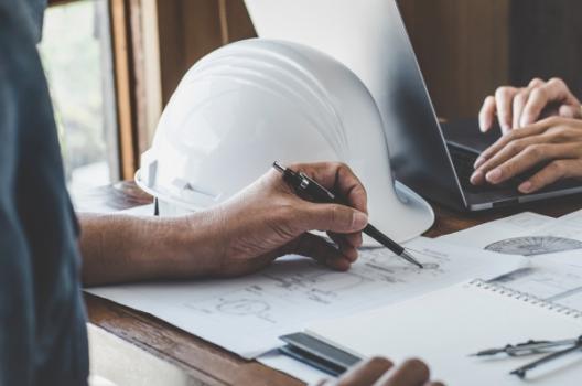 Person sketching on plans