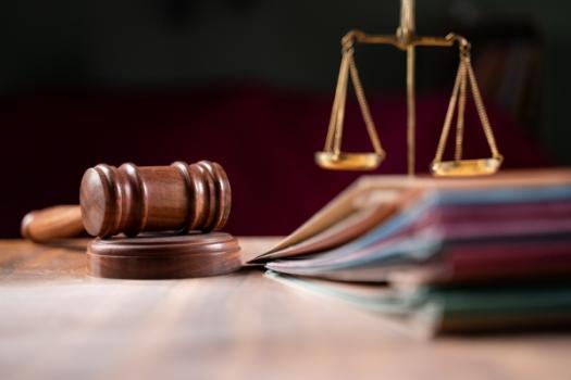 Gavel next to scale and files