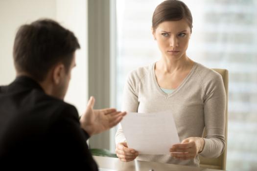 Woman frowning at document