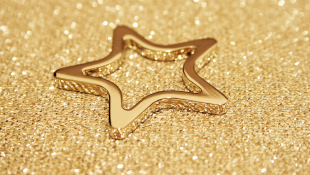Gold star on sand