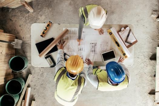 Construction workers meeting over plans