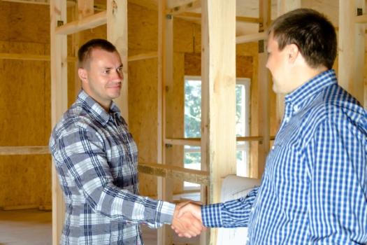 Handshake in house under construction