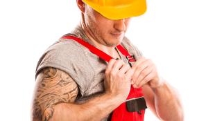 Construction worker pinning something to uniform