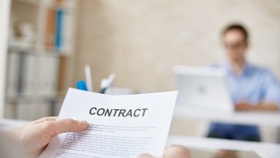 Business person holding contract