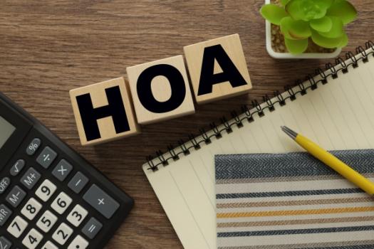HOA Fines Capped at $100: Immediate Impact of California’s AB 130 HOA blocks next to calculator pen and notepad