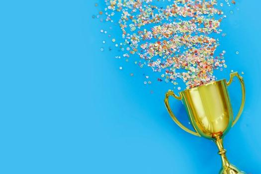 Confetti spilling out of gold trophy
