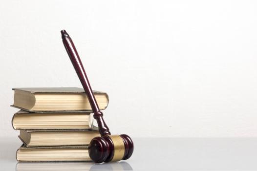 Gavel leaning on law books
