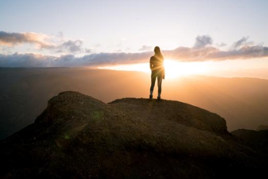 Woman on top of mountain