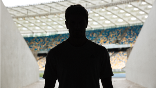 Silhouette of man entering stadium