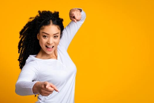 Woman pointing in gotcha pose