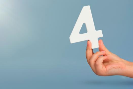 Hand holding up number four
