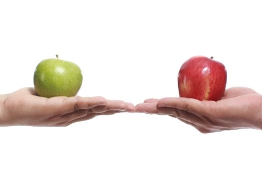 Hands holding a green and red apple