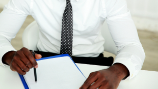 Businessman signing document