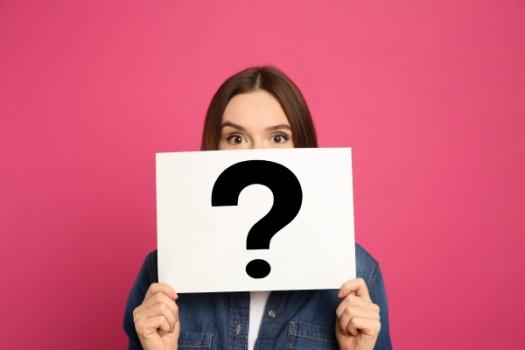 Court or Arbitration? Why Contractors Can’t Afford to Get this Wrong Woman holding up question mark sign