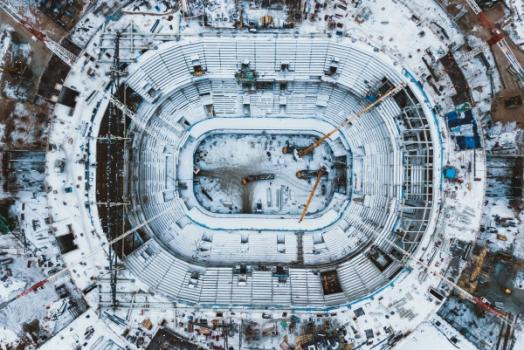 Project Team Battles Elements to Complete Buffalo Football Stadium for Next Season Aerial view of snowy stadium cranes