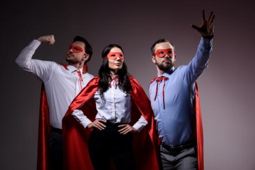 Five Kahana Feld Attorneys Recognized in 2025 Upstate New York Super Lawyers® Two men and one woman wearing superhero capes