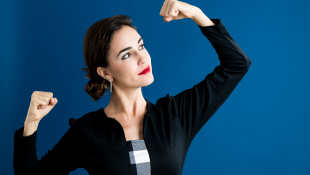 Woman holding arm up to show off muscle