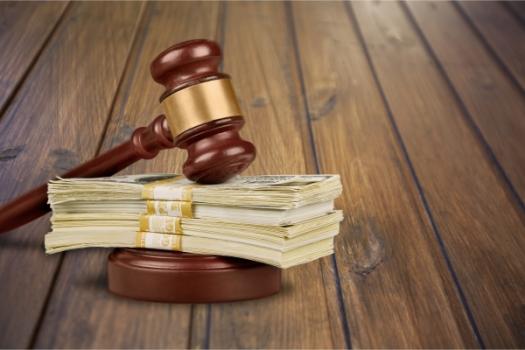 Gavel resting on cash money