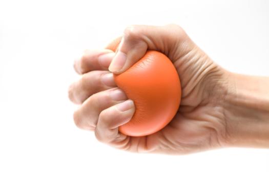 Squeezing Builders Isn’t the Way to Lower Housing Costs Hand clenching orange